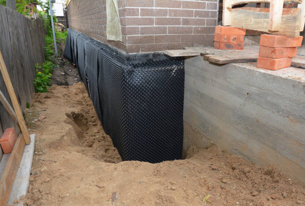 Happy homeowners after waterproofing job in Iola